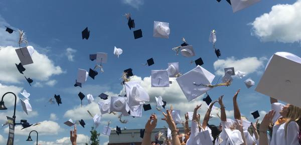 Granduation caps in the air
