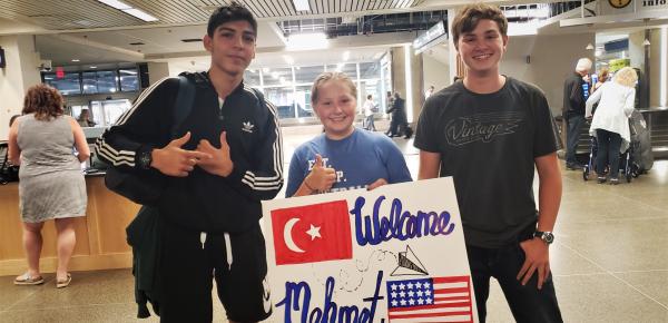 Mehmet and host siblings at the airport when he arrived