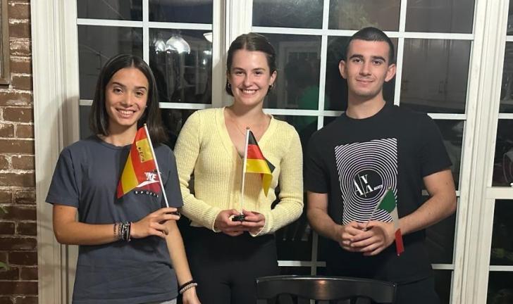 Three students holding their country's flag